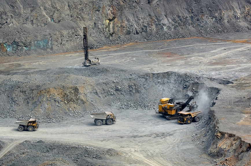 Engineers in safety gear with a tablet, cobalt mining and a Tesla Model 3